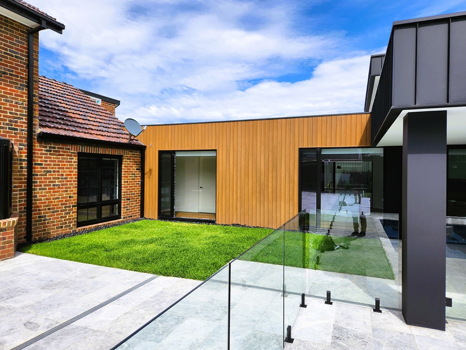 The transition point where timber lined walls and lawn meet the original brickwork.